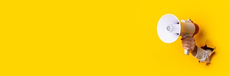 hand-holds-megaphone-hole-wall-260nw-1944738823